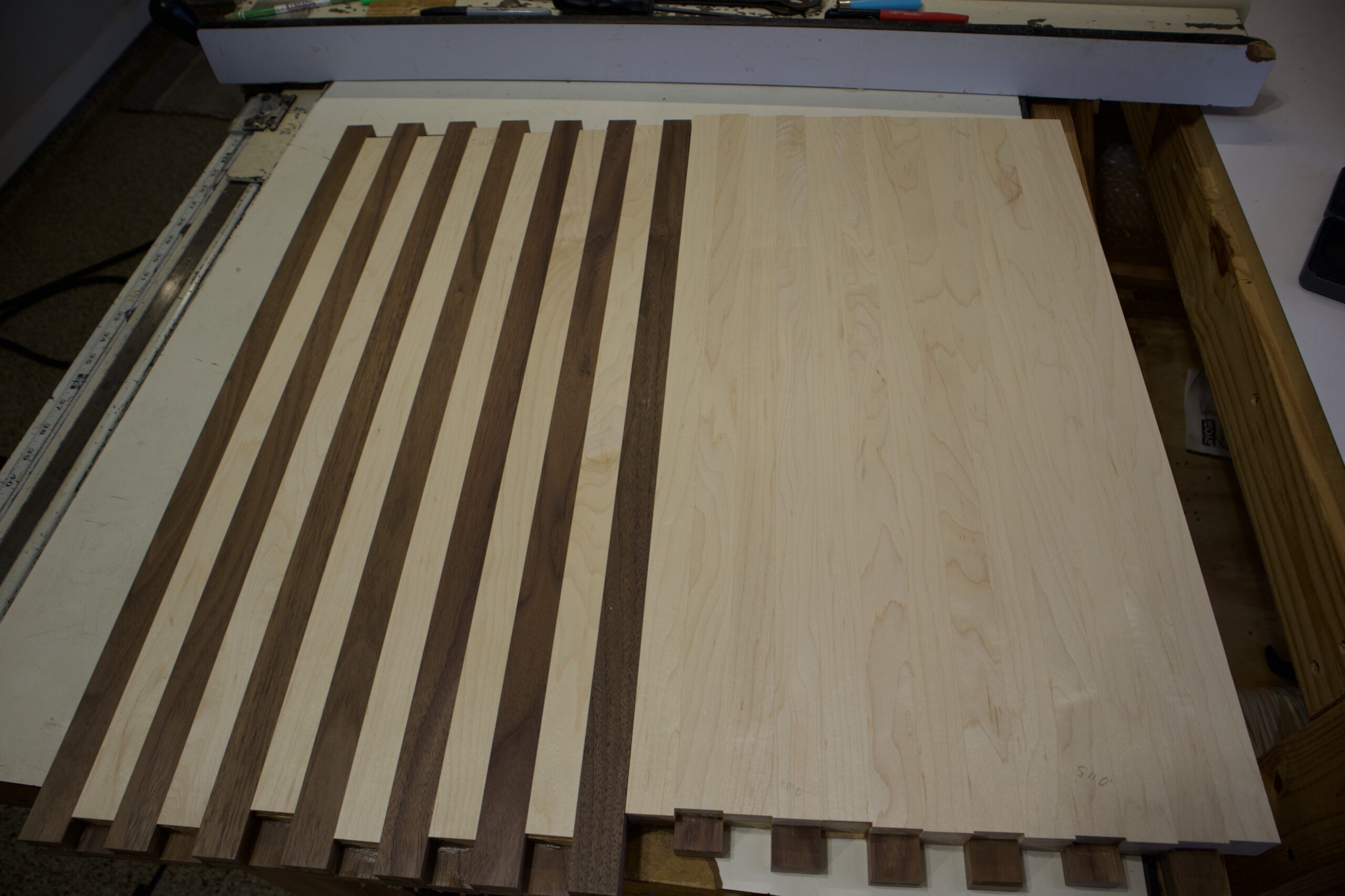 Black walnut panel with maple strip side up next to hard maple panel with black walnut strip side down