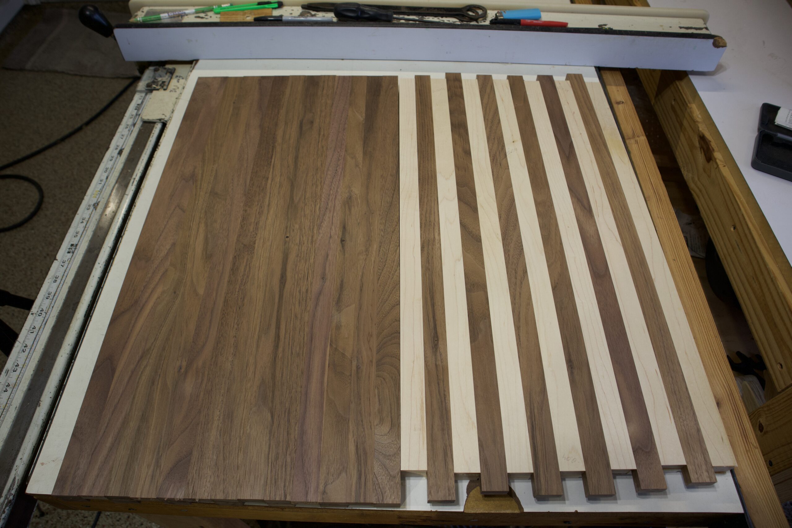 Black walnut panel with maple strip side down next to hard maple panel with black walnut strip side up